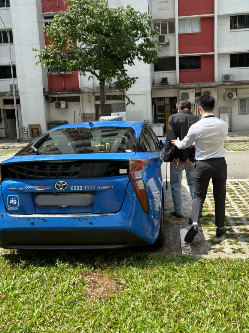 An alleged individual (left) involved in giving bribes in CPIB’s custody on 30 March 2026.